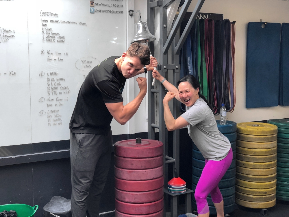 May Busch ringing personal best bell at Crossfit