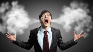 Businessman in anger screaming with smoke coming out from ears