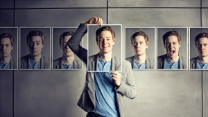 Man holding photo of himself