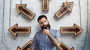 Thoughtful bearded man and lighting arrows on brick wall