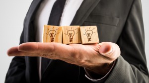 Businessman holding three wooden cubes