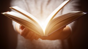 Light coming from book offering wisdom