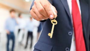 Businessman giving key to success