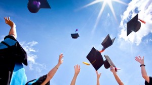 Students throwing graduation hats in the air