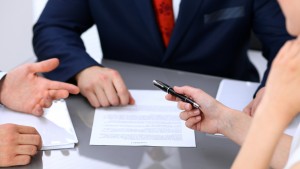 Business woman offering pen for signing contract