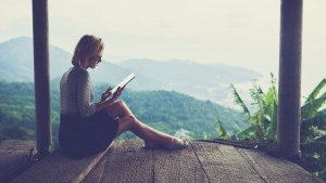 woman sitting against jungle scenery background