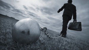 Businessman with ball and chain