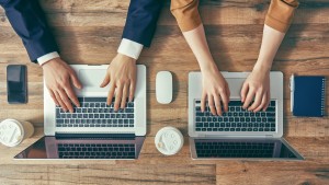 Man and woman working on their computers