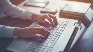 Woman typing on a laptop