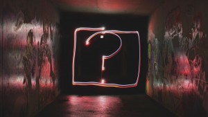 Glowing question mark in dark tunnel
