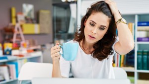 Worried woman working on her laptop at office