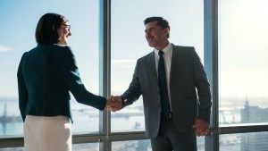Businessman and businesswoman shaking hands