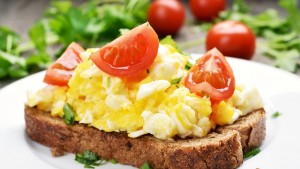 Scrambled eggs and tomato on bread