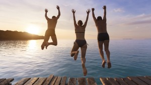 Group people jumping into the sea