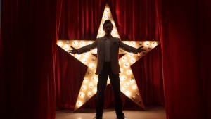 Man on stage with star on background